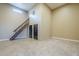 Open-concept living room features high ceilings, tile flooring, and a staircase leading to the second floor at 10033 W Jj Ranch Rd, Peoria, AZ 85383