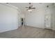 Bright living room featuring tile flooring, ceiling fan, and adjacent doorway at 10033 W Jj Ranch Rd, Peoria, AZ 85383