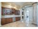 Spacious living area with wet bar, wine fridge, and tile flooring at 10033 W Jj Ranch Rd, Peoria, AZ 85383