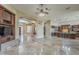 Spacious living room featuring tile flooring, archways, and a ceiling fan with light fixture at 10033 W Jj Ranch Rd, Peoria, AZ 85383