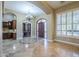 Spacious living room boasts tile flooring, archways, and elegant chandelier at 10033 W Jj Ranch Rd, Peoria, AZ 85383