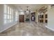 Bright living room with stone fireplace, built-in cabinets, and ample natural light from large windows at 10033 W Jj Ranch Rd, Peoria, AZ 85383