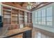 Spacious office boasts wood paneled ceiling, custom shelving, and plantation shutters at 10033 W Jj Ranch Rd, Peoria, AZ 85383