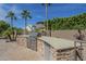 Custom stone outdoor kitchen with grill and prep area, ideal for outdoor gatherings at 10033 W Jj Ranch Rd, Peoria, AZ 85383