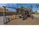 Backyard shot of a wooden playground with swings, ladders, and a slide on a sunny day at 10033 W Jj Ranch Rd, Peoria, AZ 85383
