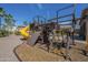 An alternate angle of the wooden playground including a slide and climbing structures at 10033 W Jj Ranch Rd, Peoria, AZ 85383