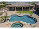 Aerial view of a private pool, spa, and outdoor kitchen in a luxurious backyard at 10033 W Jj Ranch Rd, Peoria, AZ 85383