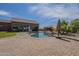 Beautiful backyard pool area with a view of the home's architecture and a play area at 10033 W Jj Ranch Rd, Peoria, AZ 85383