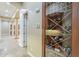 An indoor wine cellar with a glass door displays a collection of bottled wines at 10033 W Jj Ranch Rd, Peoria, AZ 85383