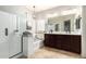 Bright bathroom with a dual vanity, soaking tub and glass-enclosed shower at 11755 W Patrick Ln, Sun City, AZ 85373