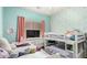 A bedroom featuring bunk beds and a single bed plus a large window with natural light at 11755 W Patrick Ln, Sun City, AZ 85373