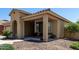 Charming single-story home with a cozy front porch, desert landscaping, and neutral color scheme at 11755 W Patrick Ln, Sun City, AZ 85373