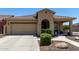 Inviting single-story home with a well-manicured lawn, covered porch and a two-car garage at 11755 W Patrick Ln, Sun City, AZ 85373