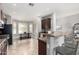 Eat-in kitchen with a breakfast bar, stainless steel appliances, and a view of the outdoor dining area at 11755 W Patrick Ln, Sun City, AZ 85373