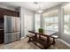 The eat-in kitchen features a dining area with a modern light fixture and great natural lighting at 11755 W Patrick Ln, Sun City, AZ 85373