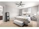 Spacious main bedroom with a plush bed, neutral tones, and view to the ensuite bath at 11755 W Patrick Ln, Sun City, AZ 85373