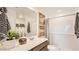 Well-lit bathroom featuring a shower-tub combo and vanity with ample counter space at 12039 E Primrose Ln, Florence, AZ 85132