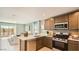 Modern kitchen with stainless steel appliances, white countertops, and a sliding glass door leading to patio at 12039 E Primrose Ln, Florence, AZ 85132