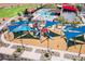 Aerial view of a colorful playground with modern equipment and sunshades, part of a vibrant community at 12039 E Primrose Ln, Florence, AZ 85132