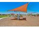 Well-maintained playground with swings, climbing frames, and shade covers for year-round enjoyment at 12039 E Primrose Ln, Florence, AZ 85132