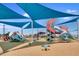 A well-equipped playground featuring slides, climbing structures, and covered areas for shaded play at 12039 E Primrose Ln, Florence, AZ 85132