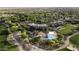 Aerial view showcasing community amenities including a pool, clubhouse, tennis courts, and lush landscaping at 13186 W Via Dona Rd, Peoria, AZ 85383