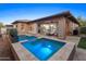 Inviting backyard features a modern pool and spa, perfect for outdoor relaxation and entertainment at 13186 W Via Dona Rd, Peoria, AZ 85383