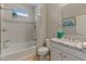 Bathroom featuring a shower-tub combination, white tile, and granite vanity with decorative accents at 13186 W Via Dona Rd, Peoria, AZ 85383