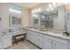 Primary bathroom with dual sinks, granite countertop and spacious walk-in shower at 13186 W Via Dona Rd, Peoria, AZ 85383