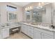 Bathroom featuring a double sink vanity with a granite countertop and framed mirrors at 13186 W Via Dona Rd, Peoria, AZ 85383