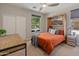 Cozy bedroom featuring a Murphy bed, a modern ceiling fan, and bright natural light at 13186 W Via Dona Rd, Peoria, AZ 85383