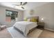 A serene bedroom featuring neutral tones, accent pillows, and natural light from the window at 13186 W Via Dona Rd, Peoria, AZ 85383