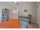 Spare bedroom featuring a ceiling fan, modern desk, and ample space, ideal for a home office at 13186 W Via Dona Rd, Peoria, AZ 85383