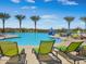 Resort-style community pool with lounge chairs, palm trees, and ample space for recreation at 13186 W Via Dona Rd, Peoria, AZ 85383