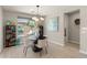 Bright dining area with modern lighting and view of outdoor lounge and pool at 13186 W Via Dona Rd, Peoria, AZ 85383