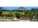 Exterior view of a desert landscaped yard and golf course with beautiful mountain views at 13186 W Via Dona Rd, Peoria, AZ 85383