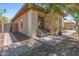 Charming exterior nook with seating area, stone accents and surrounding garden at 13186 W Via Dona Rd, Peoria, AZ 85383