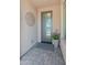 Inviting front entryway with a glass door, stylish decor, and brick flooring detail at 13186 W Via Dona Rd, Peoria, AZ 85383