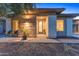 Charming home featuring a stone facade and a well-lit entrance with a lovely garden at 13186 W Via Dona Rd, Peoria, AZ 85383