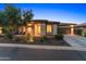 Stunning front exterior of home with stone accents, mature landscaping, and a long concrete driveway at 13186 W Via Dona Rd, Peoria, AZ 85383