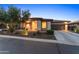 Beautiful front exterior of home with manicured landscaping, stone accents, and long driveway at 13186 W Via Dona Rd, Peoria, AZ 85383