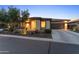 Gorgeous home exterior with stone accents, mature landscaping, and a long concrete driveway at 13186 W Via Dona Rd, Peoria, AZ 85383