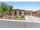 Lovely home exterior with desert landscaping, concrete driveway, and stone facade at 13186 W Via Dona Rd, Peoria, AZ 85383