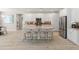 Large kitchen island featuring granite countertops and seating area, with white cabinets and stainless appliances at 13186 W Via Dona Rd, Peoria, AZ 85383