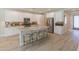 Modern kitchen with white cabinets, granite countertops, and stainless steel appliances at 13186 W Via Dona Rd, Peoria, AZ 85383