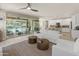 A stylish living room featuring contemporary decor, and an open layout that connects to the outdoors at 13186 W Via Dona Rd, Peoria, AZ 85383