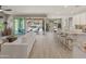 Open-concept living room with a view of the patio, which has a pool, dining area and kitchen at 13186 W Via Dona Rd, Peoria, AZ 85383