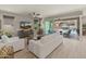 Bright living room with modern white furnishings and sliding glass doors to the outdoor patio at 13186 W Via Dona Rd, Peoria, AZ 85383