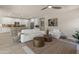 An inviting living area with kitchen, showcasing an open layout and comfortable seating arrangement at 13186 W Via Dona Rd, Peoria, AZ 85383