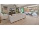 Bright living room with modern white furnishings and sliding glass doors to the outdoor patio at 13186 W Via Dona Rd, Peoria, AZ 85383